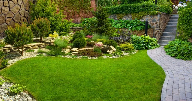 Landscaped garden beds and lawn maintained by Maintenance Masters